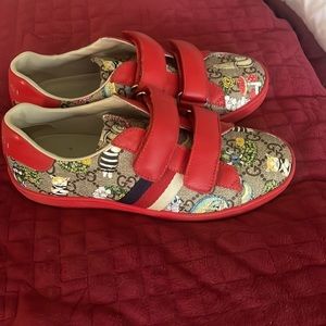 Red Gucci sneakers.